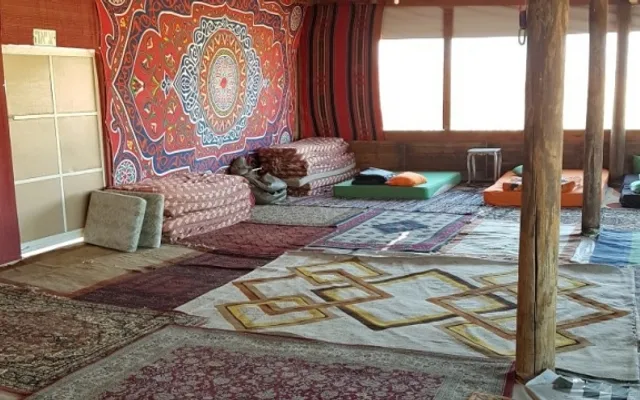 A lodging space with rugs and cushions